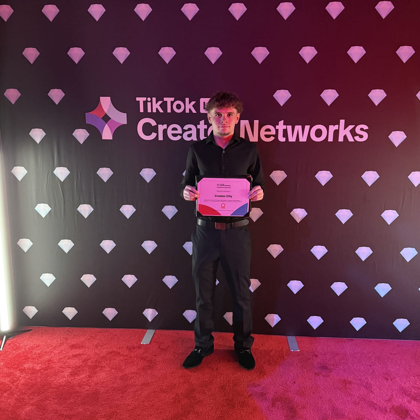Creator City founder Oliver holding the TikTok Creator Networks certificate